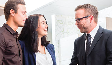 advisor skaing hands with couple