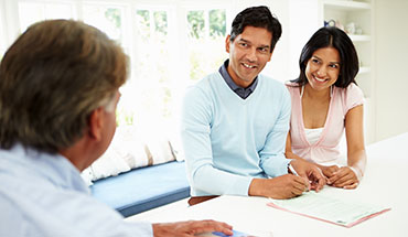 professional witnessing couple signing papers